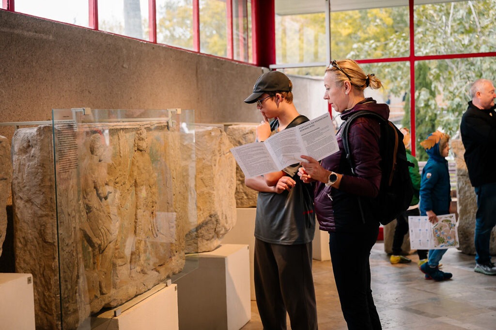 Rímske hry 2025, návštevníci pozerajú expozíciu